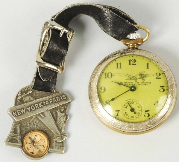 Charles Lindbergh Pocket Watch.: 1928. Made by Ingraham. Watch is running. Very scarce watch comes in different variations. This example has a watch fob that shows the plane "New York to Paris" with the Statue of Liberty on one side 