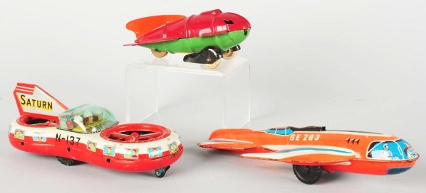 Lot of 3: Robot Toys.: Includes a pressed steel Spaceship made by Wyandotte with deterioration to the rubber wheels and a tin litho and painted friction Saturn Spaceship made by Asahitoy with several areas of wear and touch