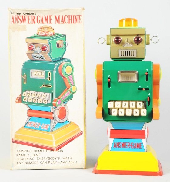 Tin Litho & Painted Answer Game Machine Robot.: Japanese. Made by Ichida. Battery-operated and working. Includes original box, inserts, and instruction sheet. Box with one area of paper lifting to face. Condition Toy (Near Mint) Box (Excellent). Si