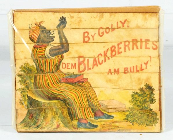 Scarce African American Mammy Puzzle.: Scarce seven-piece horizontal puzzle showing African American Mammy eating blackberries while sitting on tree stump. Slogan, "By Golly Dem Blackberries am Bully". Some staining and creasing. Condition
