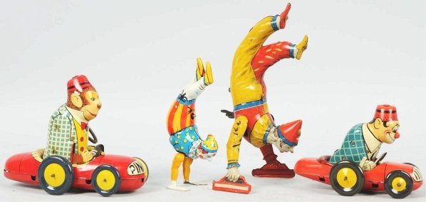 Lot of 4: Tin Litho Figural Wind-Up Toys.: German. Working. Includes two monkeys in automobiles, one marked "Pinky" in front, and two hand-stand clowns in different size variations. Condition (Excellent). Size Largest: 7" T.