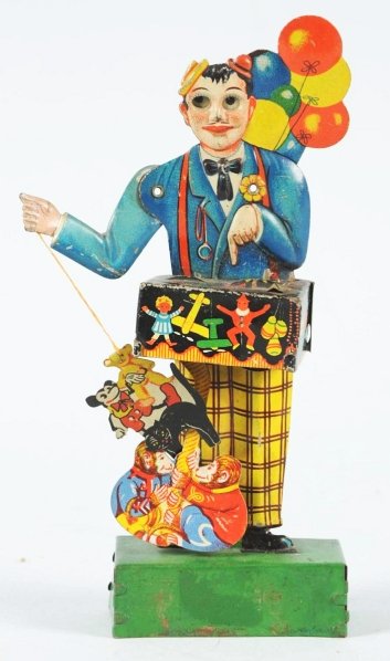 Tin Litho Balloon Vendor Wind-Up Toy.: German. Working. Includes Mickey Mouse in toy pack that is attached to the balloon vendor's arm with string. When wound, balloon vendor's eyes and arm move up and down. Some scratching and wear overal