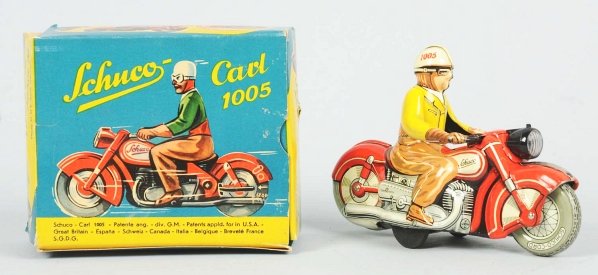 Tin Litho Schuco Motorcycle Wind-Up Toy.: German. Working. Scarce version with original key. Cycle is marked "Made in US Zone Germany". Includes colorful original box marked "Carl 1005". Box has slight creasing. Condition (Excellent - Near Mi