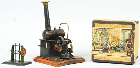 Tin Ernst Plank Stationary Live Steam Engine.: German. Tin on wooden base. Original burner and stack. Needs to be repaired and put back together. Includes original box with nice color paper label. Condition (Very Good). Size Box: 5 - 3/4" x 5 - 3/