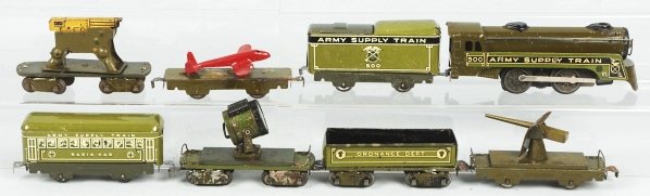 Tin Litho Marx Army Supply Train.: American. Electric style no. 500 engine with matching tender and six cars. Cars include two gun cars, one searchlight car, one flat car with restored airplane, one Ordinance Department flat car, and o