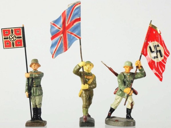 Lineol & Elastolin Flagbearers.: Contains a standing Lineol German with a replaced flag. The British is possibly a re-cast and the attacking German has cracks. Condition (Good - Very Good).