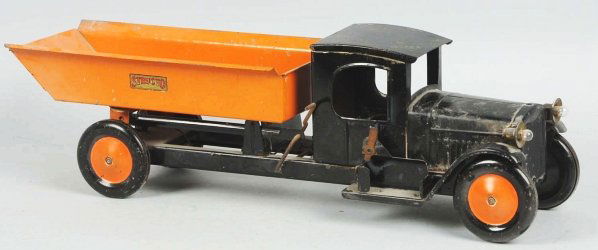 Pressed Steel Structo Dump Truck Toy.: American. Electric headlights and nice Structo decals on both sides of rear dump. Tin solid disc wheels. All original but does have some paint crazing and oxidation spotting on roof, hood, and front f