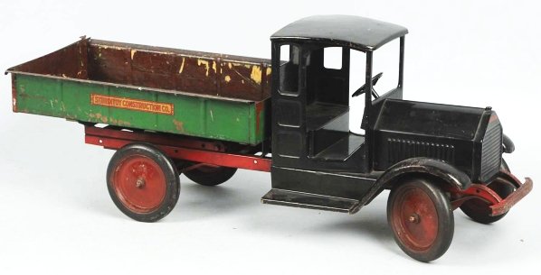 Pressed Steel Sturditoy Dump Truck Toy.: American. Original decals on grille and Sturditoy Construction Co. decals on both sides of rear dump. Original back tailgate. Some wear and repainting to dump bed. Also, small denting, scratching, and
