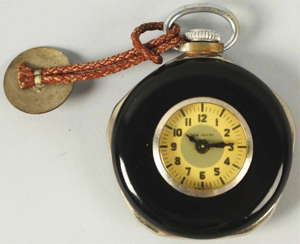 Lone Ranger Western Character Pocket Watch.: 1940. New Haven. Working. Decal of Lone Ranger riding Silver on back has some chipping and wear. Lapel cord on top with Hi Ho Silver the Lone Ranger metal pin. Condition (Very Good).
