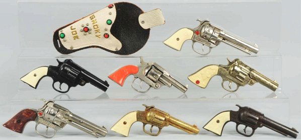 Lot of 7: Cast Iron Guns.: Six are in working condition. The dark finish Hi Ranger is not in working condition and is loose. Condition (Very Good - Excellent). Size Largest: 8 - 1/2" L.