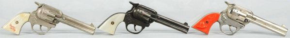 Lot of 3: Gene Autry Cap Guns.: All in working condition. Two are dummies and all show use. Grip stains and bumps. The orange gripped gun has been heavily polished. Condition (Very Good). Size Each: 8 - 1/2" L.