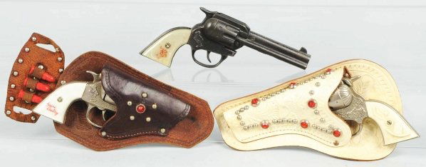 Lot of 3: Gene Autry Cap Guns & Holsters.: One holster is marked Gene Autry. All three guns are working. Condition (Very Good - Excellent). Size Largest: 8 - 1/2" L.