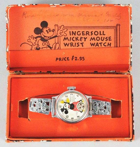Walt Disney Mickey Mouse Character Wrist Watch.: Circa 1935 to 1936. Made by Ingersoll. Working. Metal band with Mickey emblems. Three Mickey's running act as the second hand. Includes original critter box with insert. Some writing to inside of box