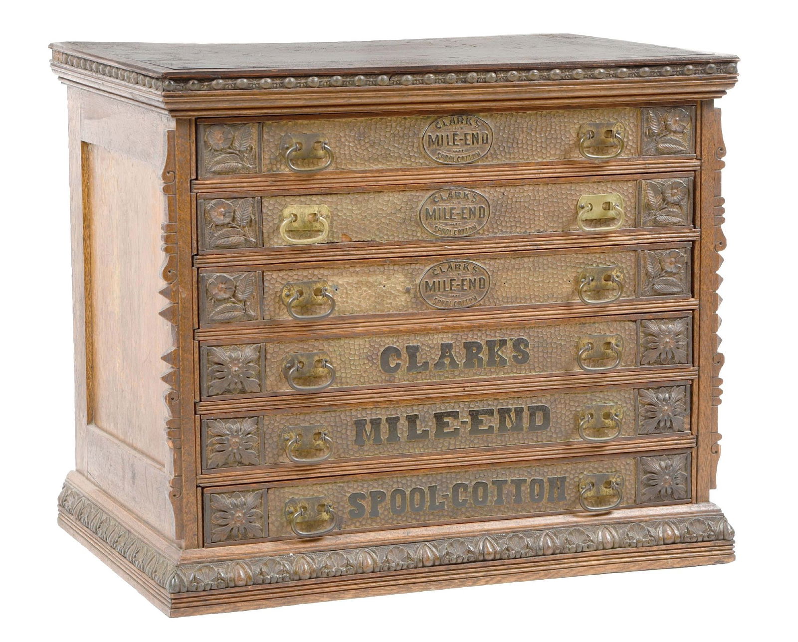 CLARK'S MILE-END SPOOL COTTON CHEST: This c. 1910s display chest from Clark's Mile-End Spool Cotton features six drawers with ornately embossed metal signs attached to the face of each drawer. CONDITION: The metal fronts of the drawers s