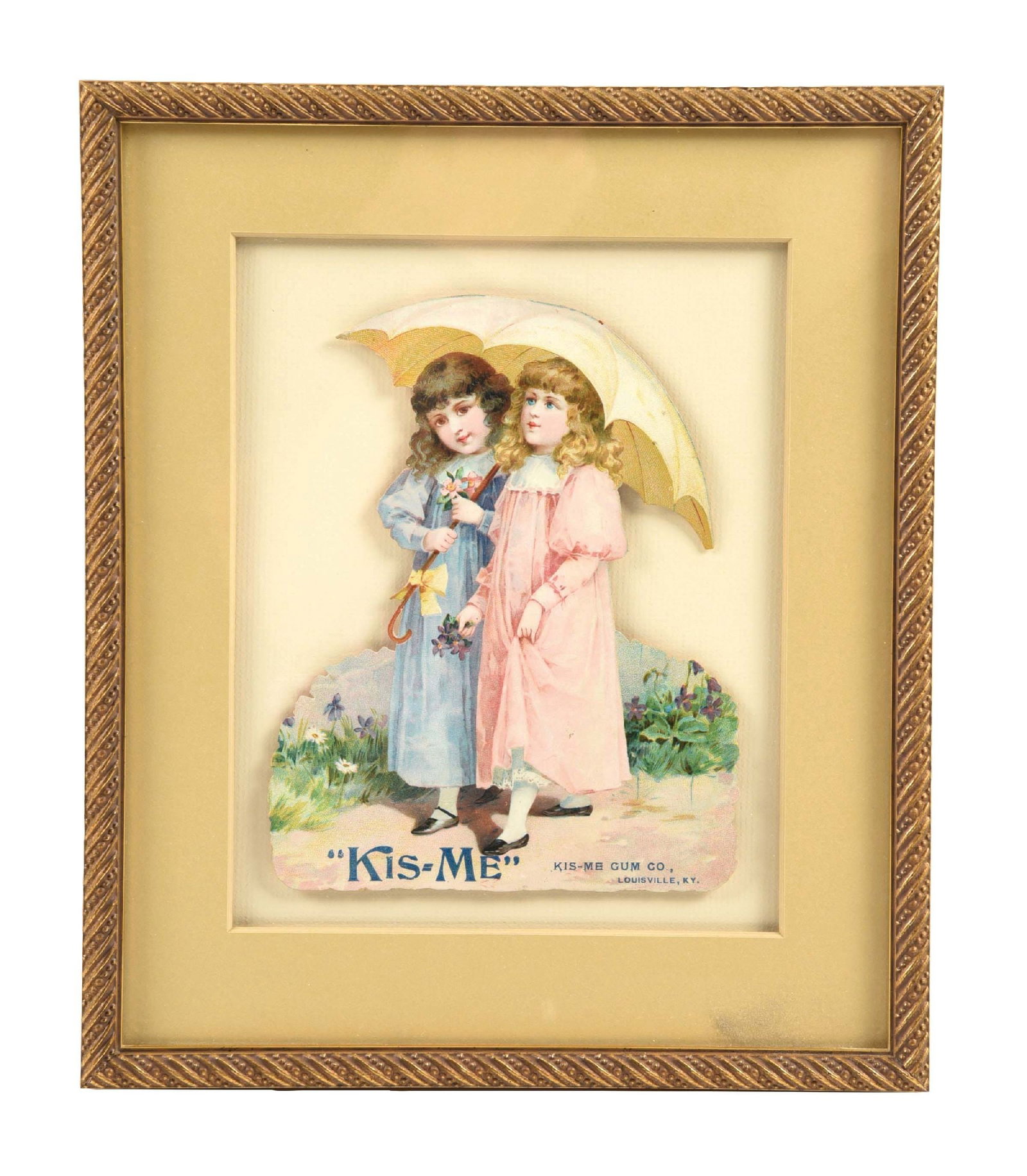 CARDBOARD "KIS-ME" CHEWING GUM ADVERTISEMENT: Single-Sided Cardboard. This c. 1910s die-cut pressed cardboard advertisement from Kis-Me chewing gum features two young girls walking under an umbrella. CONDITION: The field on this sign shows great 
