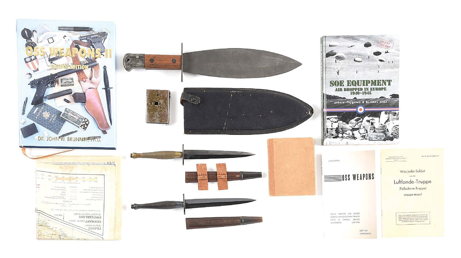 LOT OF OSS RELATED EDGED WEAPONS AND EPHEMERA.: Interesting lot of items pertaining to the OSS. There are 3 knives, 2 stilettos and 1 smatchet. The first stiletto features a brass grip with 2nd pattern style scabbard with "wings" underside of guard