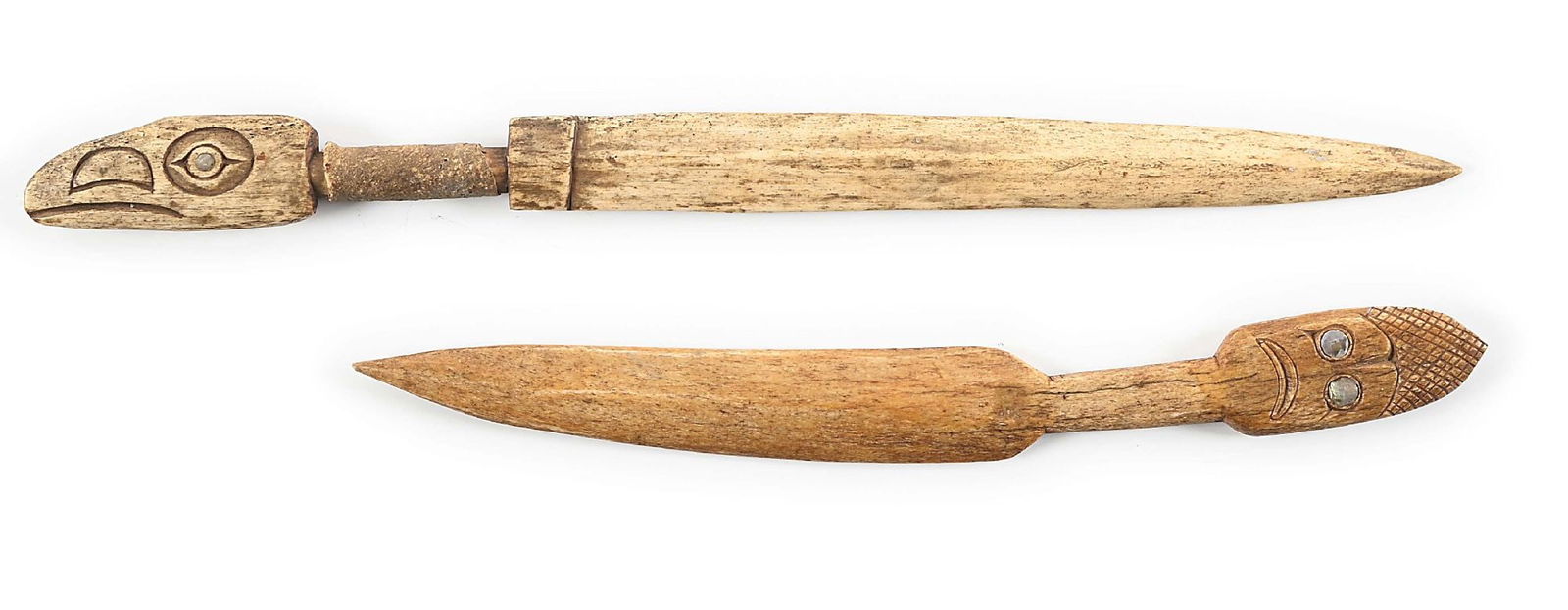 LOT OF 2: NORTHWEST COAST BONE DAGGERS.: Lot consists of: (A) Carved Tlingit whale bone knife with figural raven head pommel and abalone eyes. Center recessed grip portion is wrapped in seal or similar hide and then stitched down on the reve