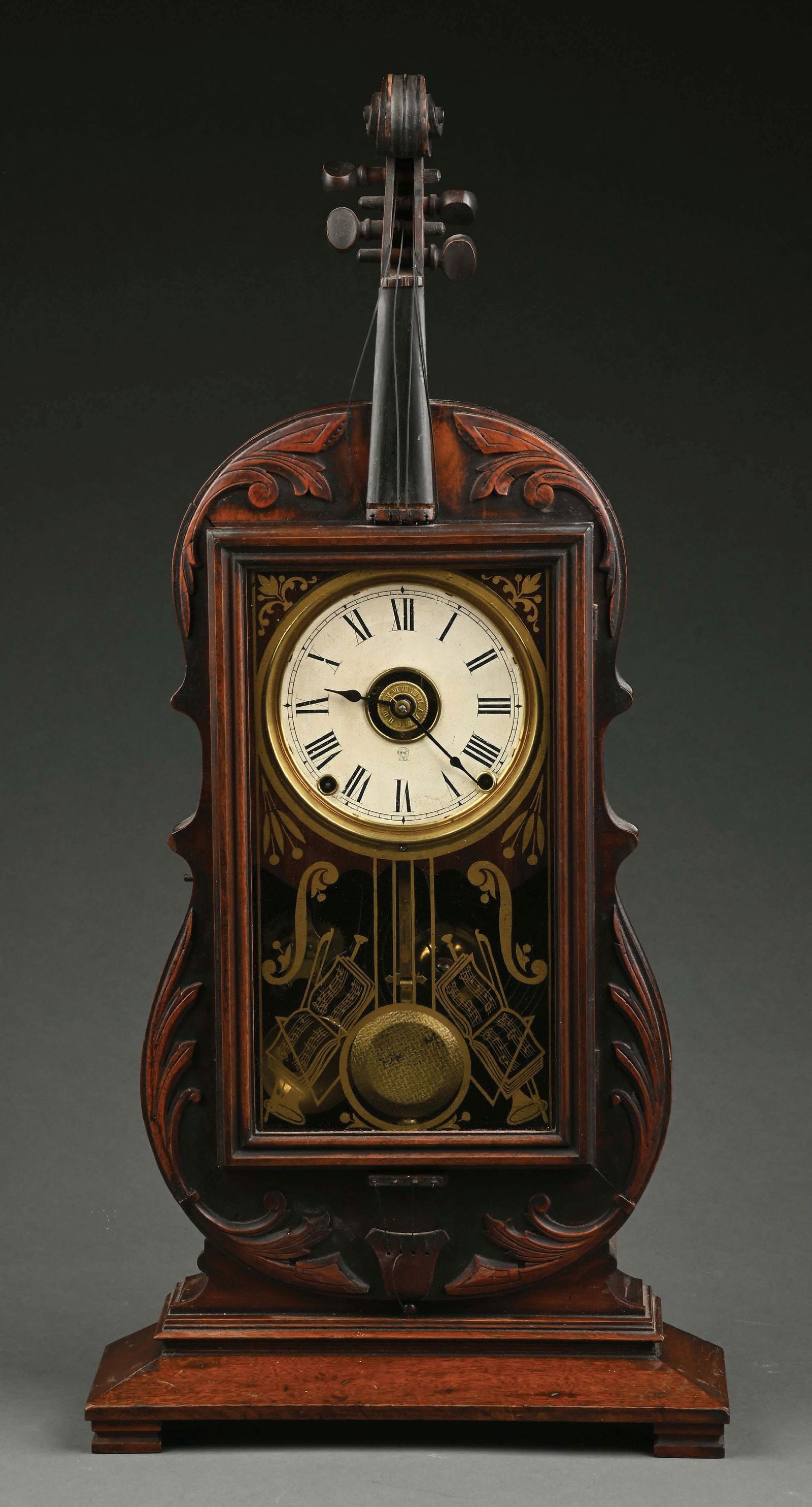 SETH THOMAS "VIOLIN" MANTEL CLOCK: Seth Thomas Violin mantel clock, 8 days, time and strike, spring driven Seth Thomas period lyre movement in a violin form walnut case with painted metal dial and musical-themed silk screened glass. Th