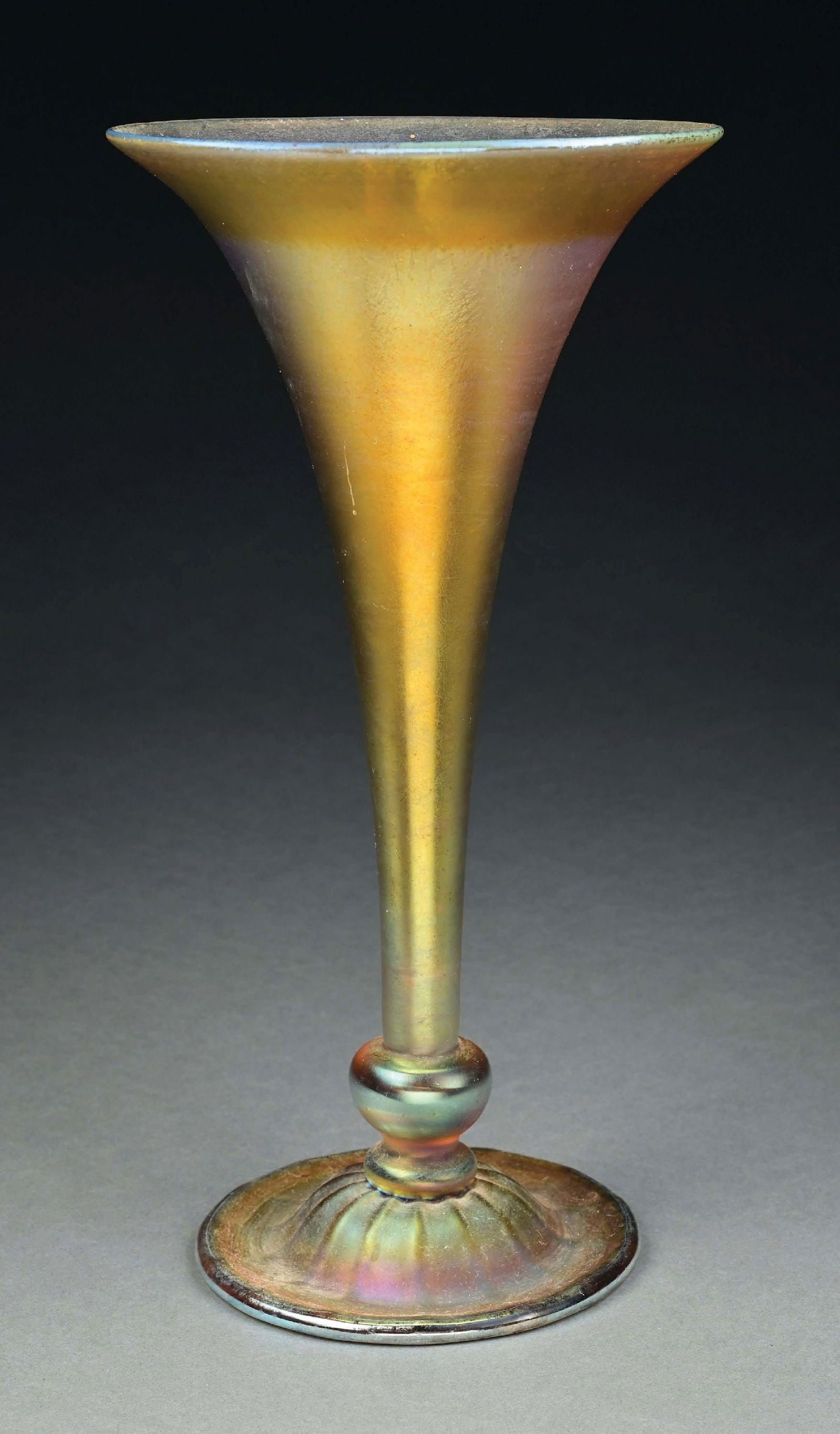 TIFFANY STUDIOS FAVRILE GLASS VASE: A gorgeous Favrile glass vase by Tiffany Studios. The conical and footed vase is composed of gold Favrile glass with nice iridescence. It has a flared mouth, tapered stem, and circular platform with r