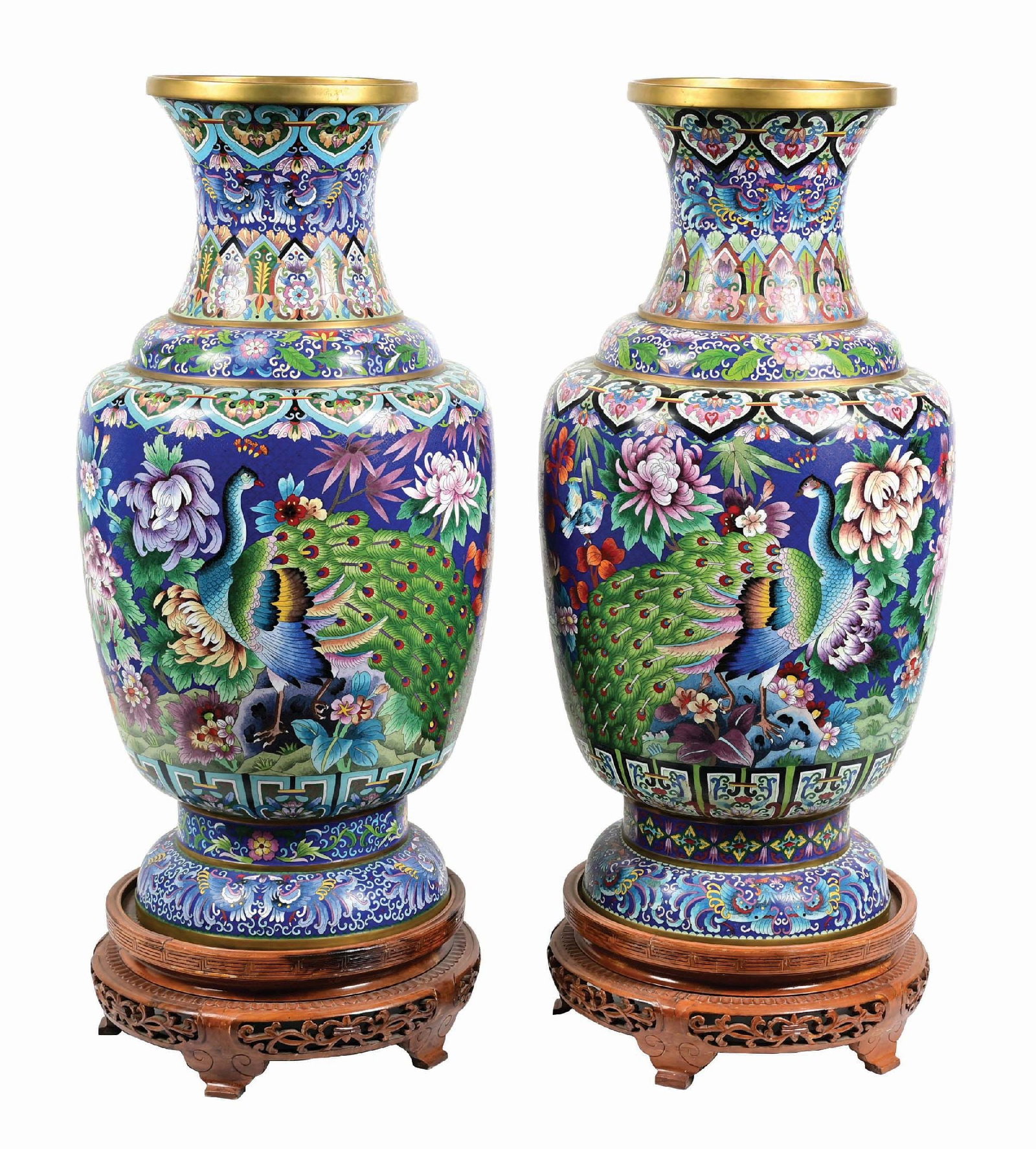 PAIR OF PALATIAL CHINESE CLOISONNE VASES: C. 1960s - 1970s. Multicolored floral designs with an array of birds, both on carved wood bases. This is not a standard shippable item and will require 3rd party shipping or pickup arrangements to be 