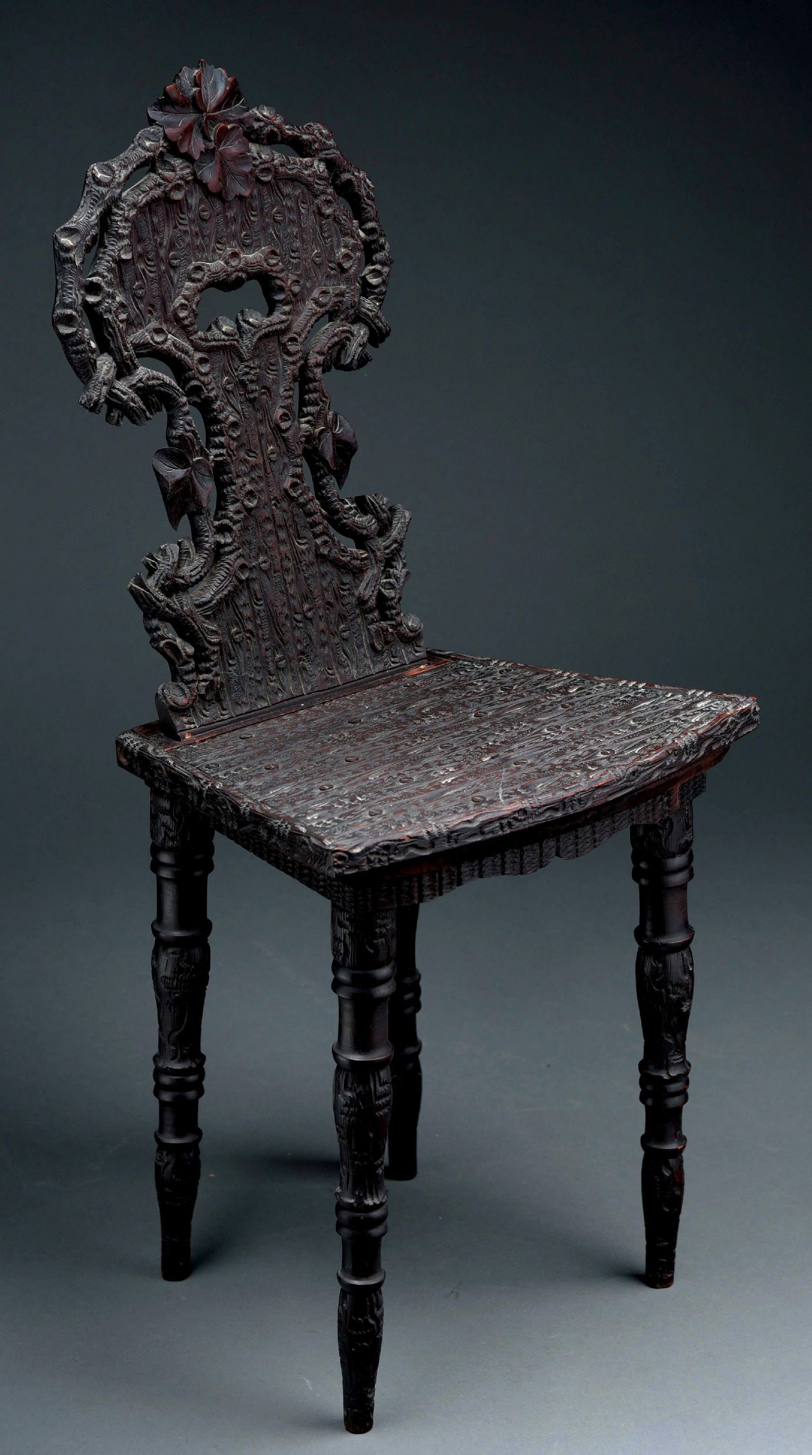 VICTORIAN ADULT SIZE MUSICAL CHAIR WITH 3" CYLINDER: Black Forest carved musical chair with wonderful wooded carvings, playing a 3" cylinder and two tunes. Activated when seated. Condition is wonderful with little wear, working properly and a great earl