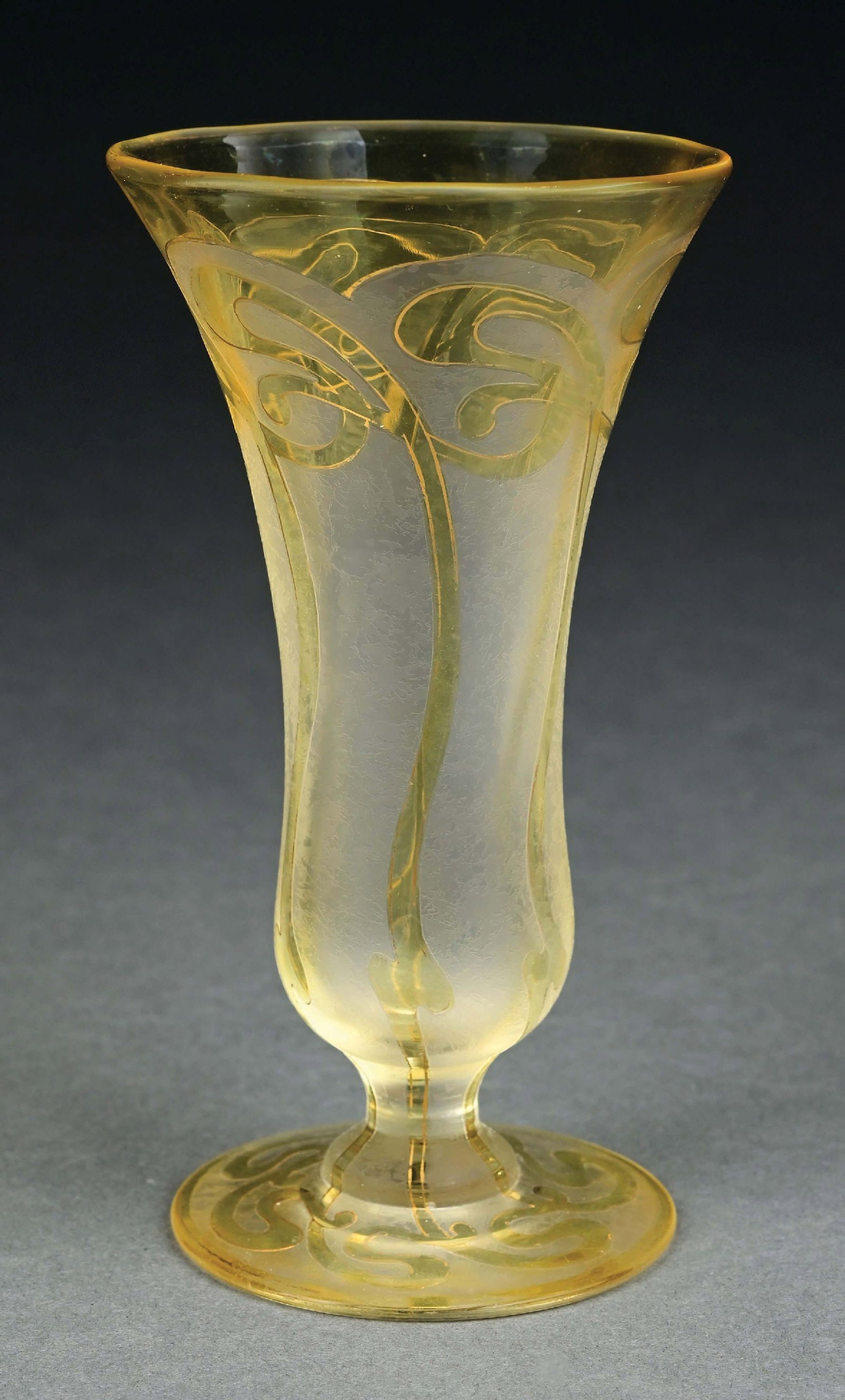 HONESDALE FOOTED CAMEO CUT VASE: A lovely glass cameo cut vase by Honesdale. The 16" tall round footed vase is composed of clear frosted glass with cameo cut and gilt overlay. The underside is signed "Honesdale." Condition: It is fre