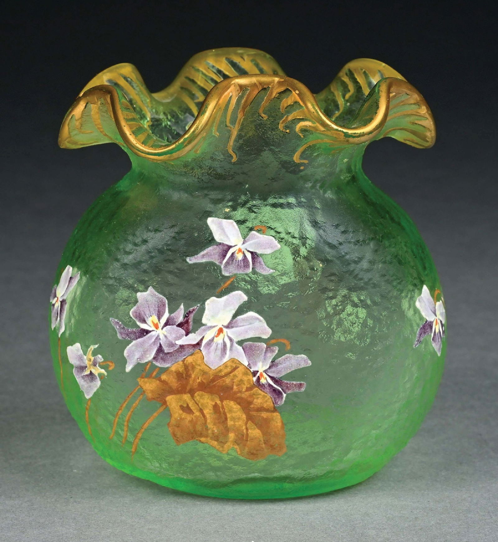 MONT JOYE ART GLASS VASE: A gorgeous art glass floral vase by Mont Joye. The vase with ruffled mouth and round bottom form, composed of green glass, with enameled flowers and gilded rim. Condition: (Excellent) Dimensions: 4 -