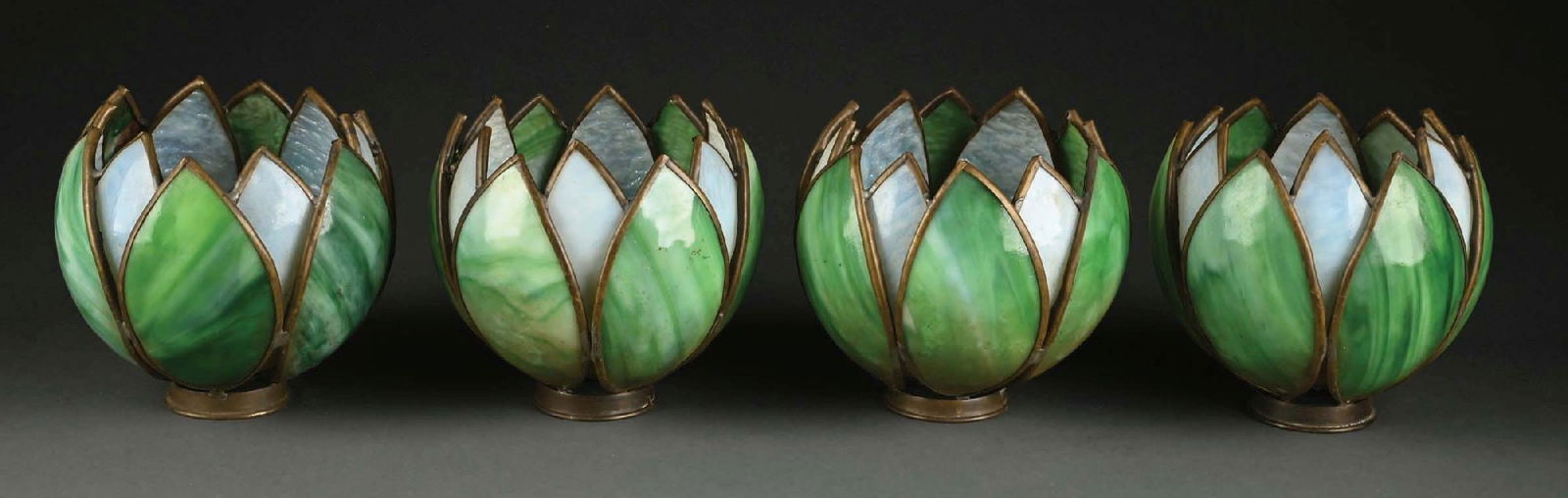 LOT OF 4: SLAG GLASS TULIP SHADES: A lovely matching set of four green and white slag glass tulip shades. Each shade is composed of alternating petals of green and white slag glass. The shades are very dirty, but free of cracks. Condit