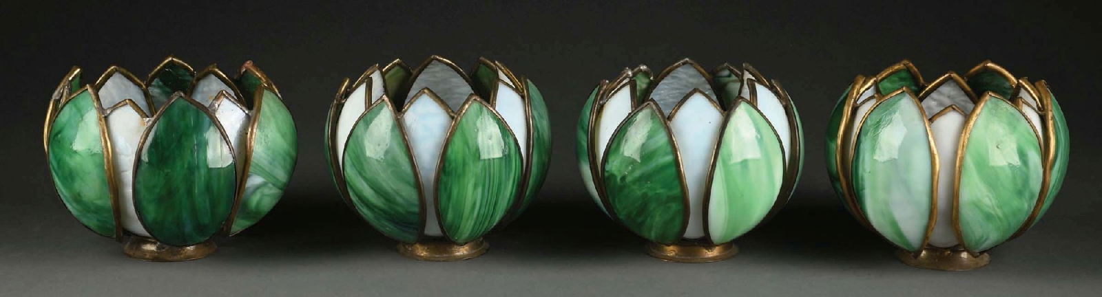 LOT OF 4: SLAG GLASS TULIP SHADES: A lovely set of four slag glass tulip shades. Each of the shades is composed of alternating green and white slag glass petals. In very good condition, with just a small number of fine cracks. Conditio