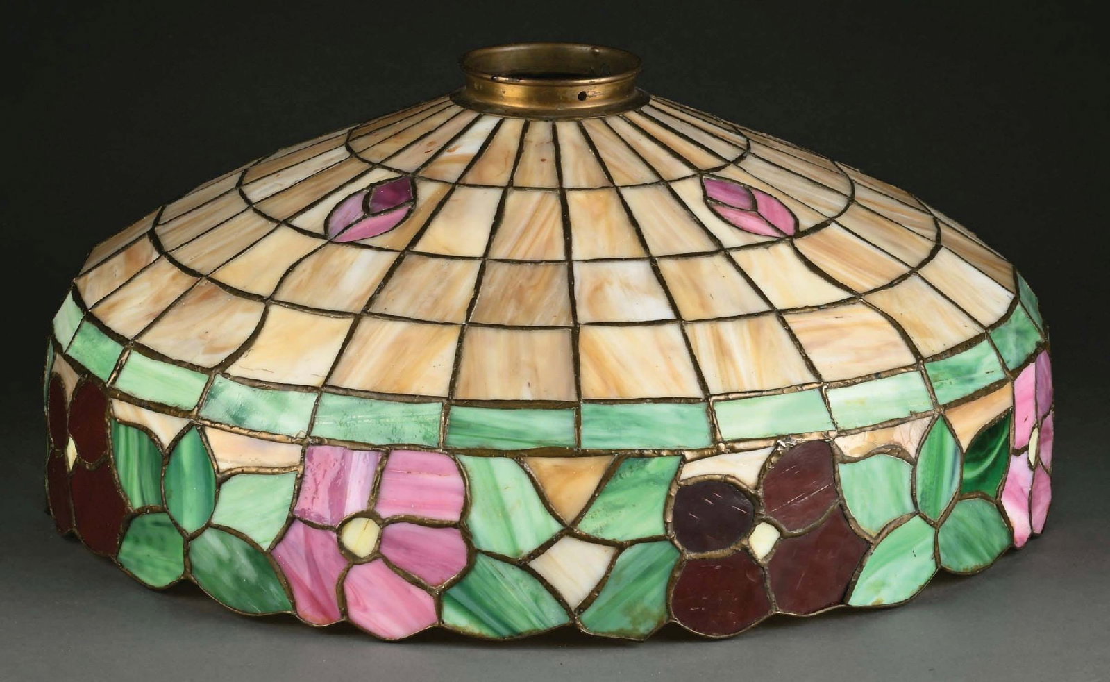 LAMB BROS. LEADED GLASS FLORAL LAMP SHADE: A lovely leaded glass shade by Lamb Bros. The 18" diameter leaded glass shade has a background of caramel-colored glass and a lower border with stylized floral motif in pinks, reds and greens. The sha