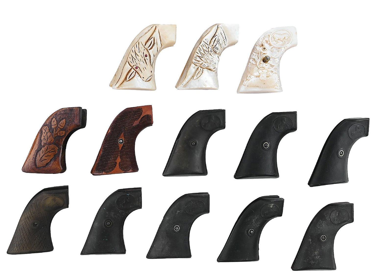 LOT OF 13 COLT SINGLE ACTION GRIPS: A nice grouping consisting of 2 pair of carved pearl longhorns, one with red eyes, a pair of Japanese style dragon carved pearls, leaf carved wood, walnut checkered, and 8 pair of hard rubber. Various