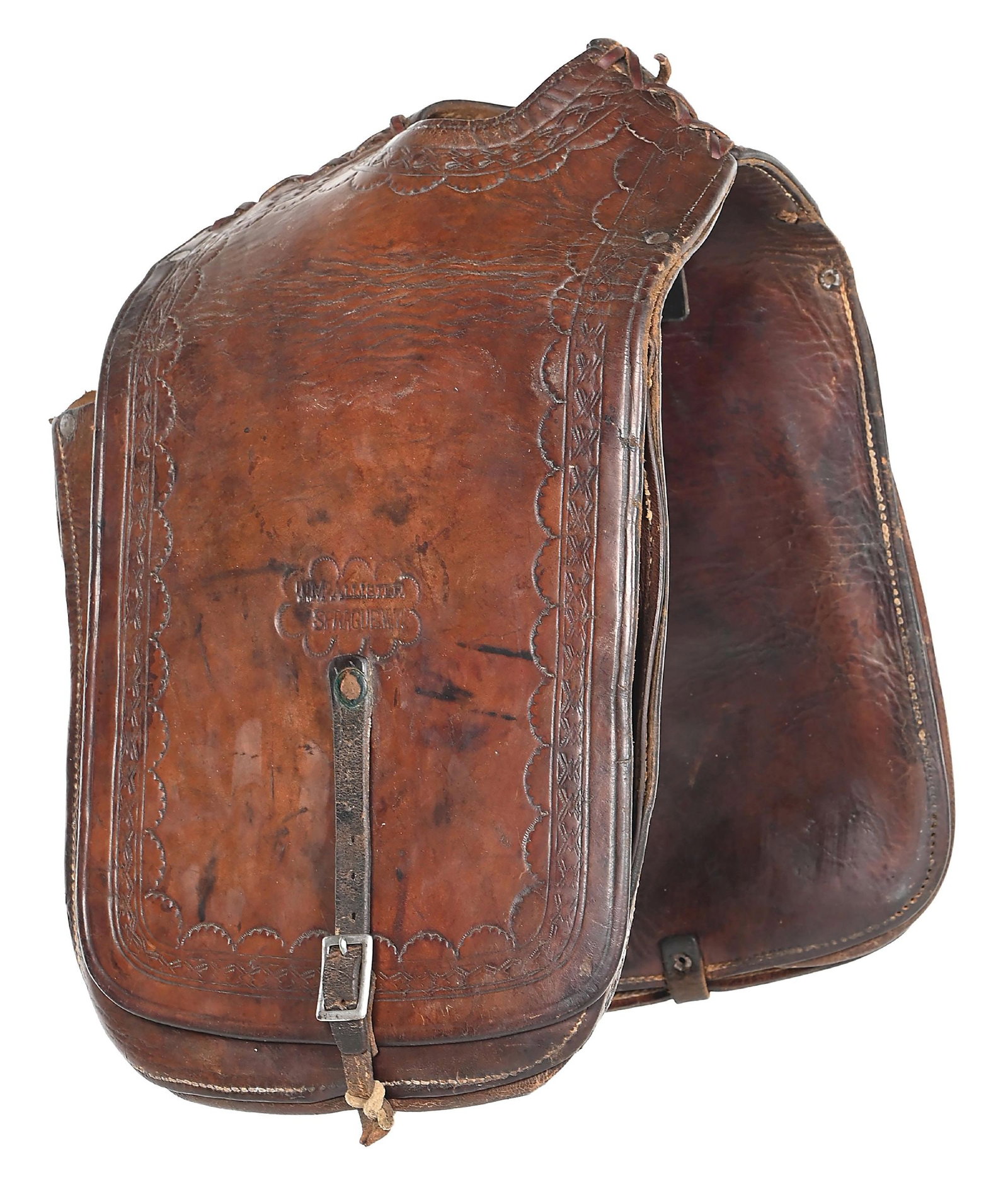 T. MCALLISTER WYOMING TERRITORY SADDLE BAGS: Maker marked early saddle pockets "T. McAllister / Sprague, W. T.". One side mounted with an original holster that appears to be for a 5" or 6" percussion revolver, as the stitching outline indicates 