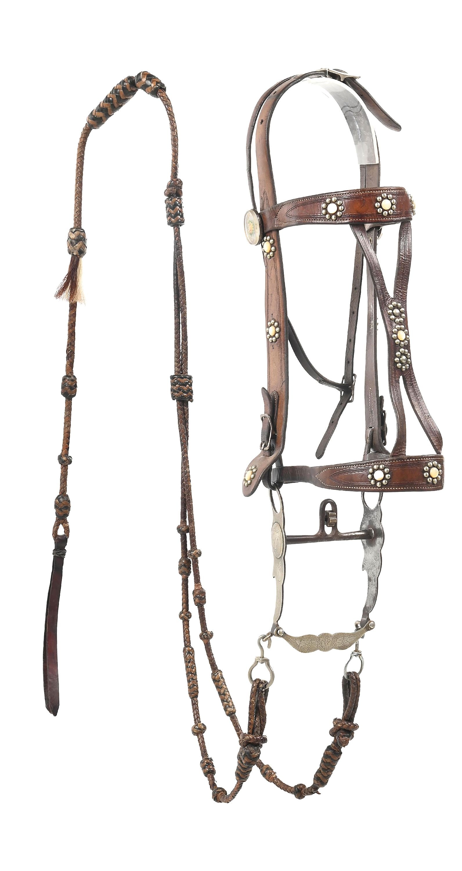CANON CITY BIT AND FANCY BRIDLE: Unmarked bridle with mother of pearl and nickel stud decoration as popular with R. T. Frazier. Heavy two-tone braided leather mains and romel and a large Canon City, Colorado prison bit with tulip eng