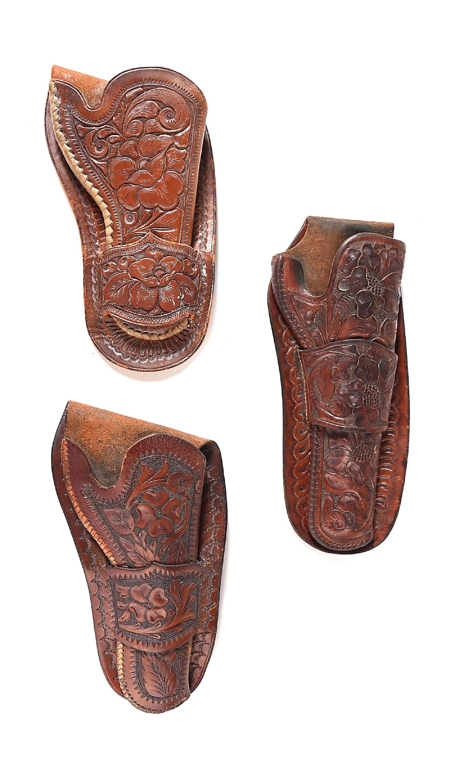 LOT OF 3 FLORAL TOOLED HOLSTERS: A group of 3 fancy single loop holsters, all very high quality carved in flower and leaf patterns a) Unmarked, for Colt Lightning Model 1877,10" x 6" overall b) Great condition for a 7 1/2" Colt Singl