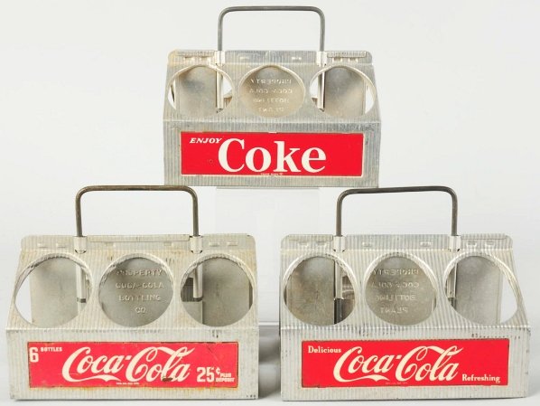 Lot of 3: 1950s Coca-Cola Aluminum Carriers.: All three variations differ. Average wear on two with the third having advanced wear and marks. Condition (Good - Excellent). Size Each: 7 - 1/4" T.