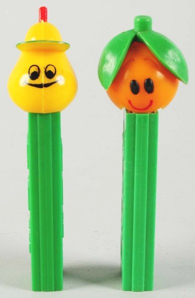 Lot of 2: Fruit Pez Dispensers.: Includes one orange and one pear. Condition (Excellent). Size Largest: 4 - 1/4" T.