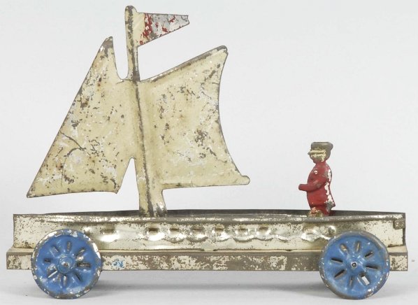 Early Tin Sailboat Platform Toy.: Probably French. Depicts a man sailing his boat. Some paint loss and wear throughout. Condition (Very Good). Size 7" L.