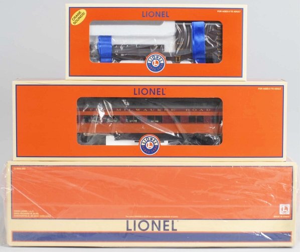 Lot of 3: Lionel Passenger & Freight Train Cars.: Contemporary. Includes one NYC boom car, one Milwaukee Road diner passenger car, and one two-pack with California Limited sleeper car and baggage car. Includes original boxes and shipping boxes. Condi