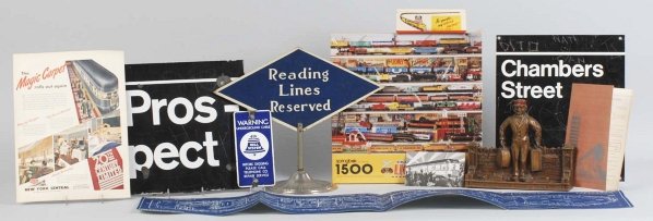 Lot of 11: Train Items.: Includes Scirocco wood tie rack, Reading Railroad sign, box of Union Pacific matches, bell system, small porcelain sin, another porcelain street sign, one Lionel Train puzzle, and some paper items. Va