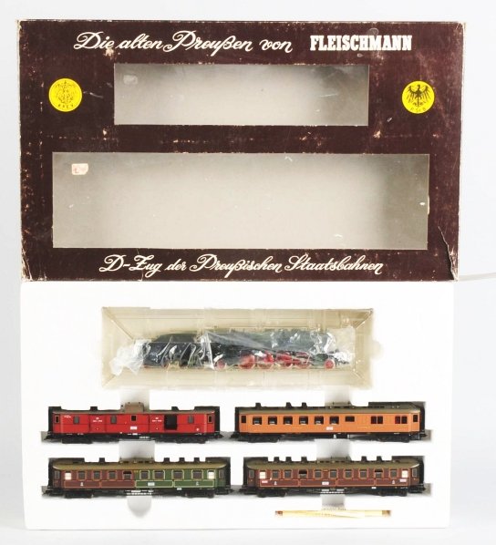 Fleischmann HO Passenger Train Set.: Contemporary. Steam-type engine with matching tender and four passenger cars. Original box marked "1885". Box has some creasing and wear. Condition Train (Excellent) Box (Very Good).