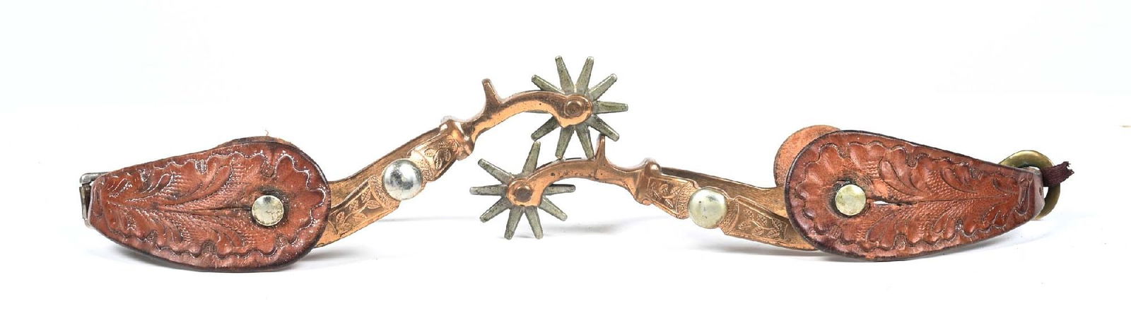 AUGUST BUERMANN SPURS: Circa 1920s matched set of 'star' marked August Buermann spurs with floral carved period leather straps. Maker stamped: HERCULES BRONZE. Measures: 1/2" band, 1 - 3/4" rowels, 2 -1/4" drop shanks, 2-3/