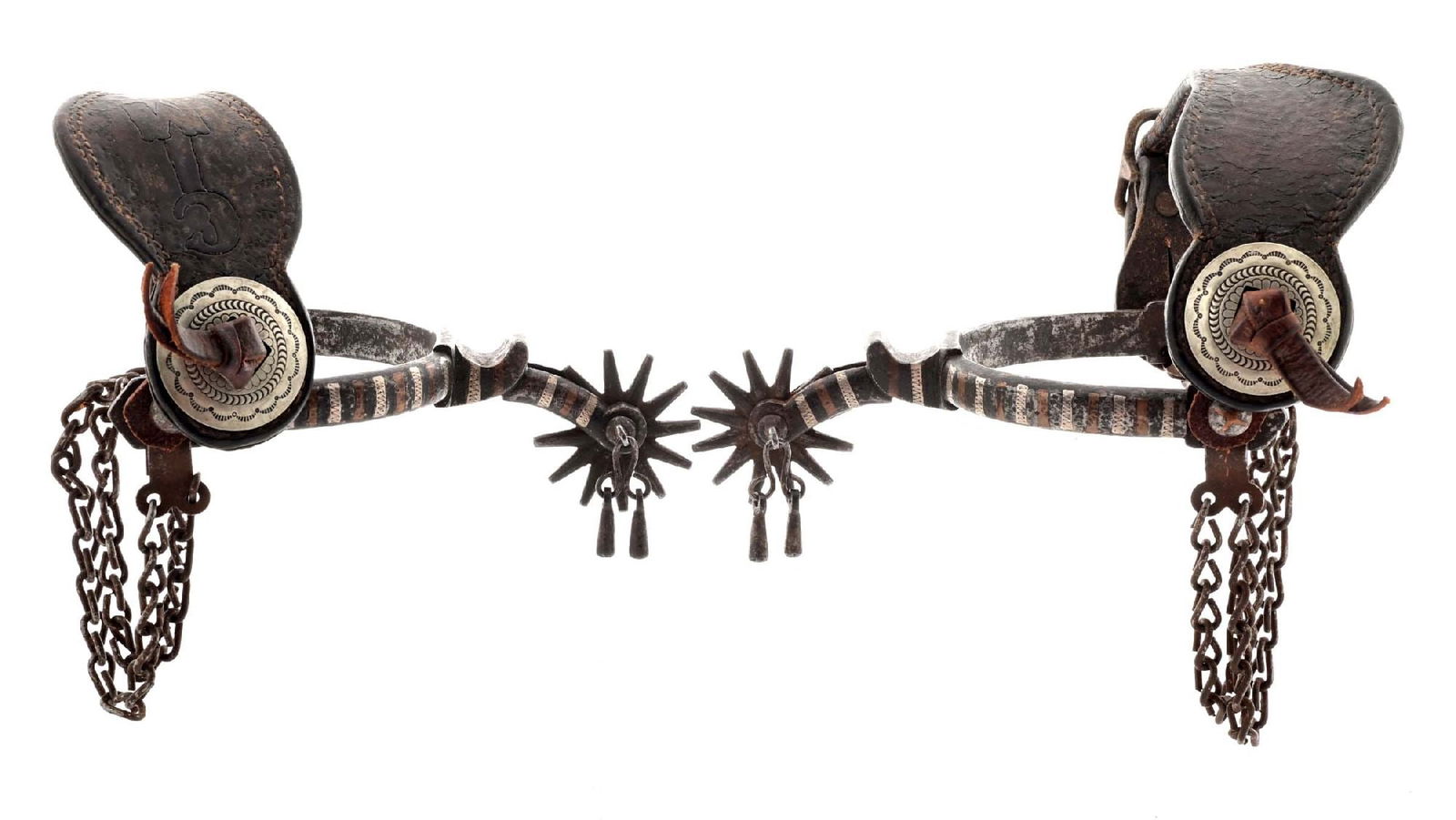 SILVER AND BRONZE BANDED SPURS.: Antique Buermann pattern spurs with a hand rocker etched bronze and silver vertical striped heel bands. 1/2" band x 2" shanks x 1 3/4" rowels with period leather straps and original jingle bobs. CONDI