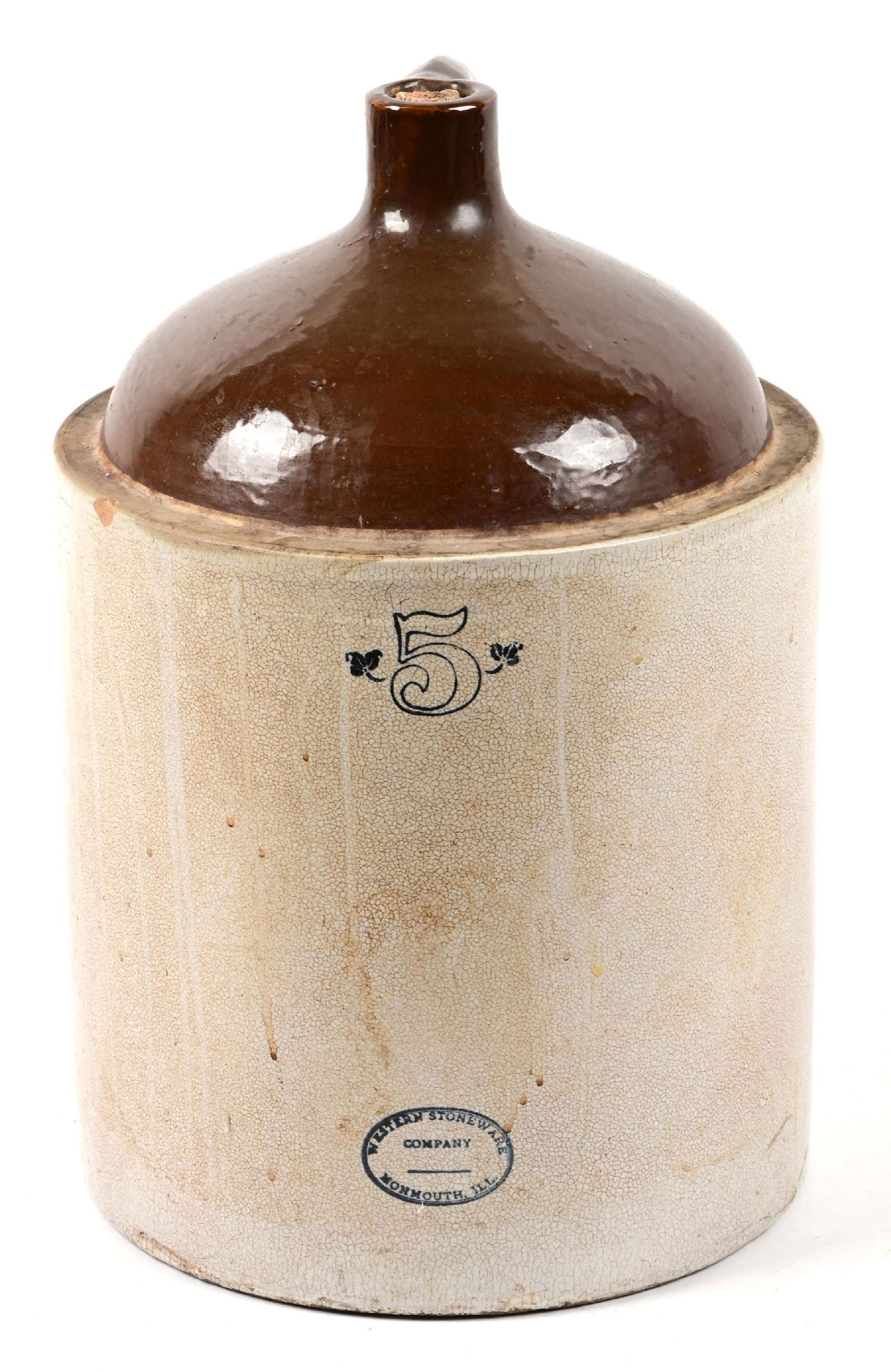 5 GALLON WESTERN STONEWARE CROCK NO. 5 JUG: Five gallon stoneware No. '5' jug by the Western Stoneware Co., Monmouth, Illinois. Remnants of original cork. Great decorator item. CONDITION: Very good. One edge flea bite, otherwise better than ave
