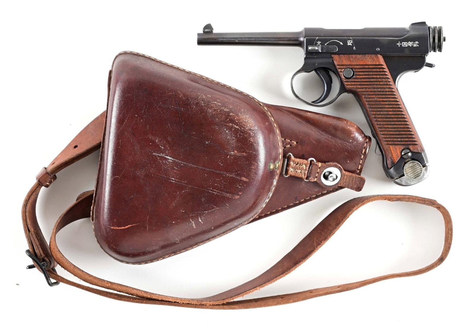 (C) JAPANESE NAGOYA MANUFACTURED NAMBU TYPE 14 8MM NAMBU SEMI-AUTOMATIC PISTOL WITH HOLSTER.: Standard military issue made at the Nagoya plant in 1942. Japanese legends found on both sides of slide, wartime blue finish, serrated walnut grips, alloy base magazine, dovetailed front sight on base