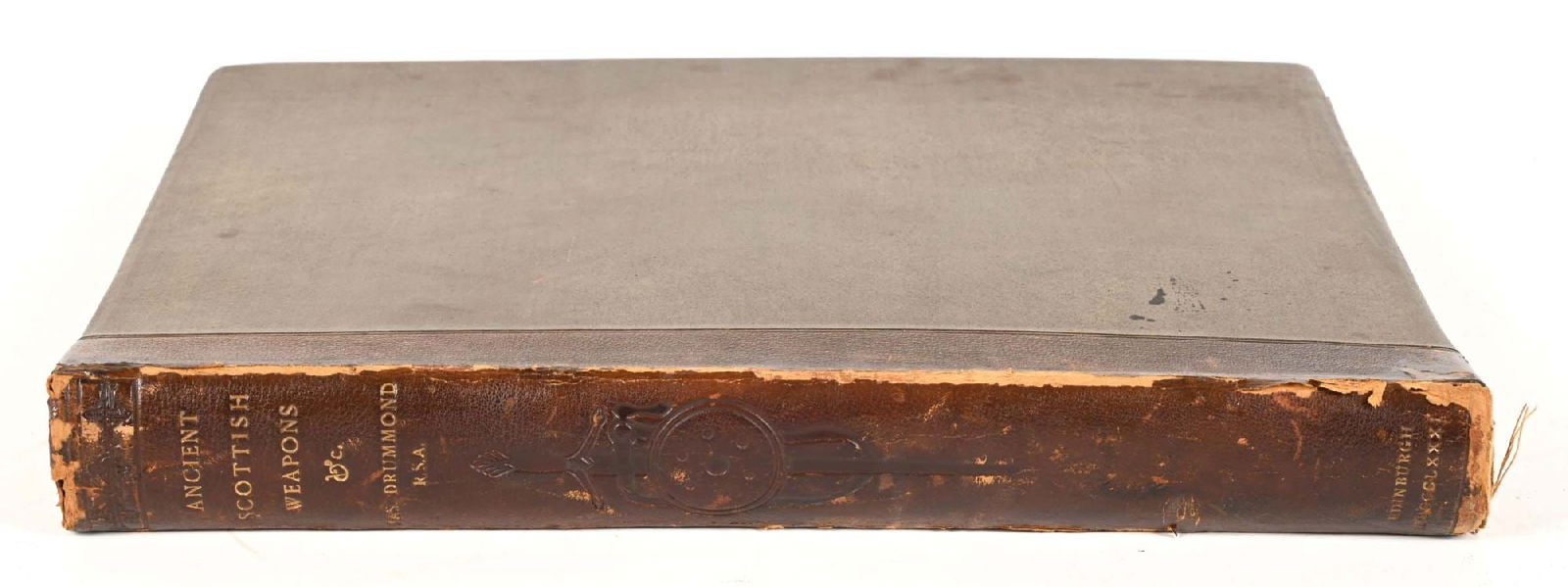 ANCIENT SCOTTISH WEAPONS BY JAMES DRUMMOND.: Bevelled brown boards, discolored, and rubbed on four leading corners. Leather spine rubbed on all edges, decorated with impressed shield and sword and lettered in faded gilt. Name plate on first blan
