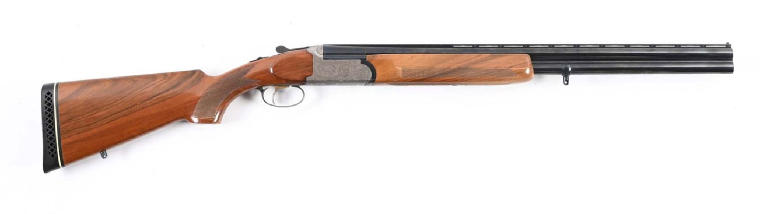 (M) ARMSPORT OVER UNDER 12 GAUGE SHOTGUN.: Features include a set of blued steel barrels with ejectors and a low-rise vent rib with a single ivory bead front sight. Engraved coin finished boxlock action, lightly checkered walnut forearm with a