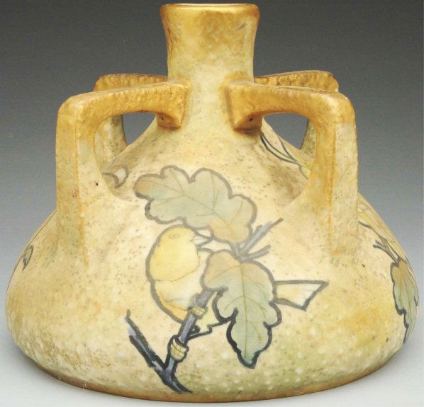 Four-Handled Amphora Ceramic Vase.: 7" T. With bird and decorated flowers between the handles. Gold, yellow, and green glazes with gold highlights. Amphora oval and crown marks. (Mint).