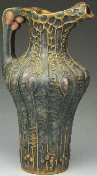 Amphora Elite Ewer.: 10" T. Art Nouveau pink buds under handle. Stylized linear relief. Probably Dachsel design. Blue, green, pink, and gold glazes. Raised Elite mark. (Mint).