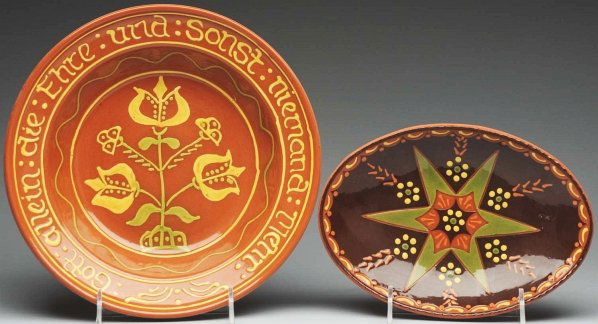 Lot of 2: Lester Breininger Redware Pieces.: Largest: 11 - 1/2" Dia. Includes one large bowl with slipware tulip decoration and German verbiage. Also includes one small oval platter decoration with a star and florals. (Excellent).