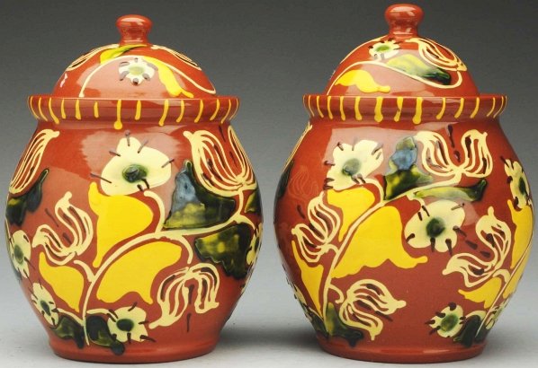 Lot of 2: Lester Breininger Lidded Jars.: Each: 8 - 3/4" T. Highly decorated in cream, green, and yellow slip. Both appear to be perfect. (Near Mint Plus).